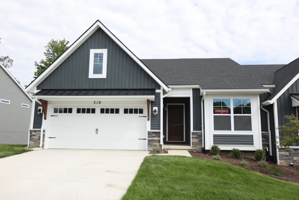 1034 Camellia Cir Unit 46, Howell, MI 48843 - craftsman inspired home with board and batten siding, stone siding, concrete driveway, and roof with shingles
