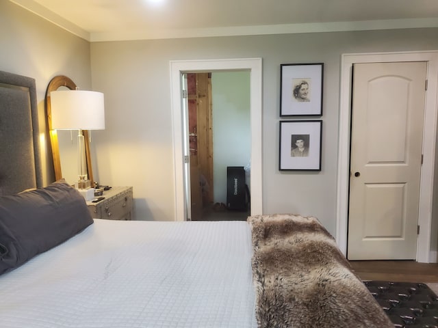 bedroom featuring dark hardwood / wood-style flooring and ornamental molding