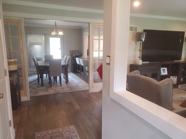 interior space featuring french doors, dark hardwood / wood-style floors, and ornamental molding