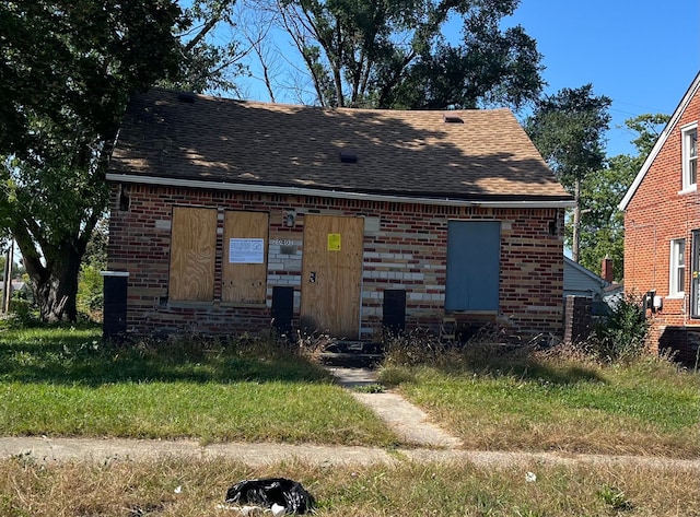 20401 Washburn St, Detroit, MI 48221 - view of front facade featuring a shingled roof and brick siding