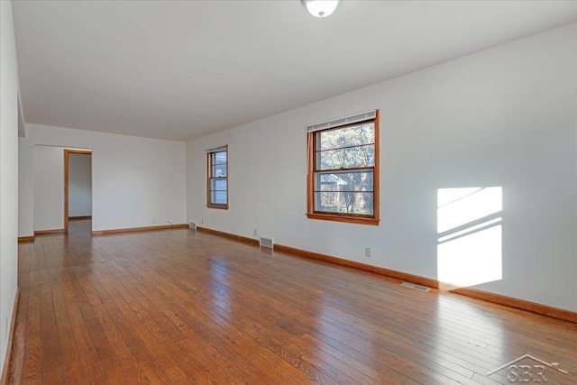 unfurnished room featuring hardwood / wood-style flooring