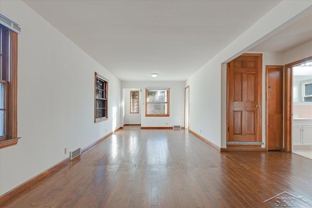 unfurnished room with hardwood / wood-style flooring