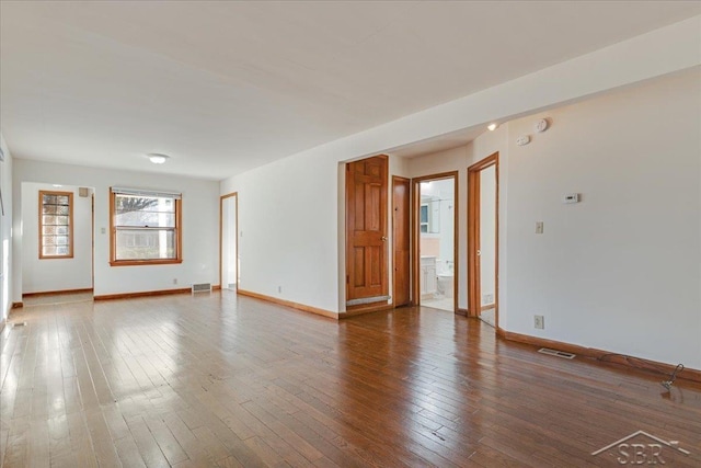 unfurnished room featuring hardwood / wood-style flooring