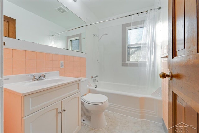 full bathroom with tile walls, decorative backsplash, vanity, toilet, and bathing tub / shower combination