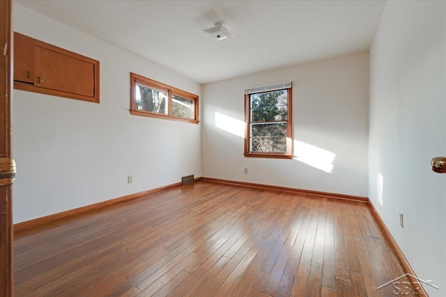 spare room with hardwood / wood-style floors