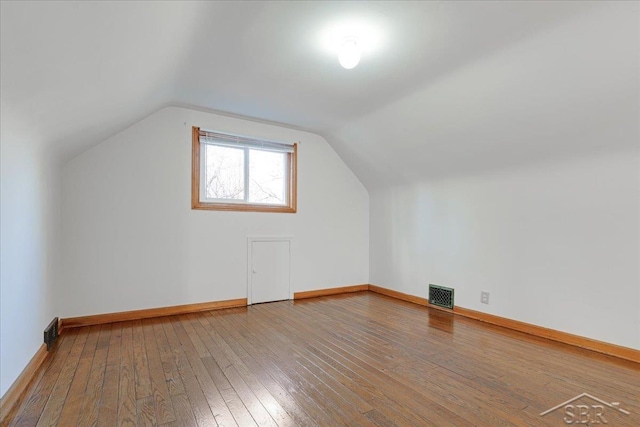 bonus room featuring hardwood / wood-style flooring and vaulted ceiling