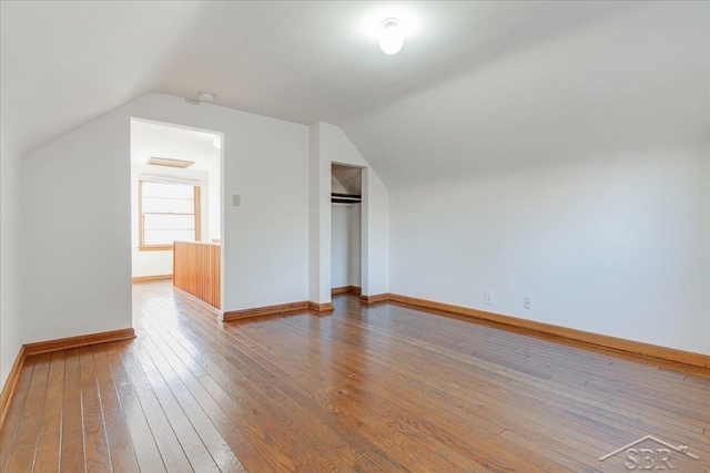 bonus room featuring lofted ceiling and hardwood / wood-style floors