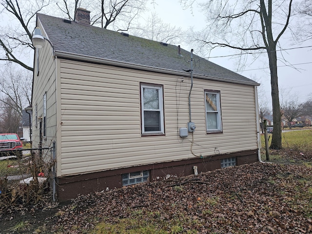19356 Huntington Rd, Detroit, MI 48219 - view of property exterior with a shingled roof and a chimney