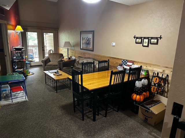 dining space with dark colored carpet and lofted ceiling