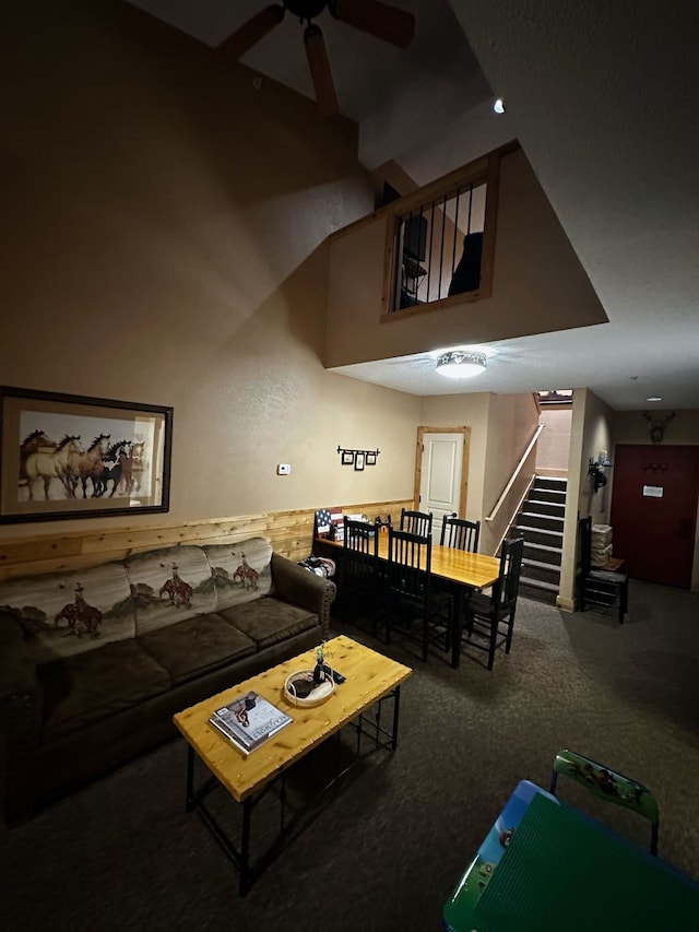 carpeted living room with ceiling fan