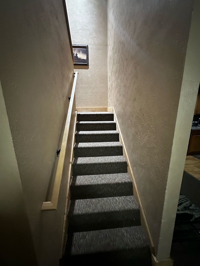 5900 Water Rd Unit 313, Rothbury, MI 49452 - staircase featuring a textured wall