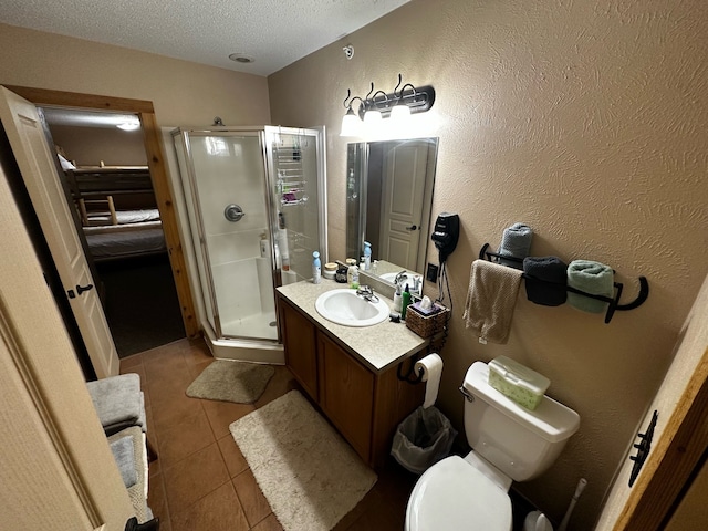 bathroom featuring tile patterned flooring, an enclosed shower, a textured ceiling, toilet, and vanity