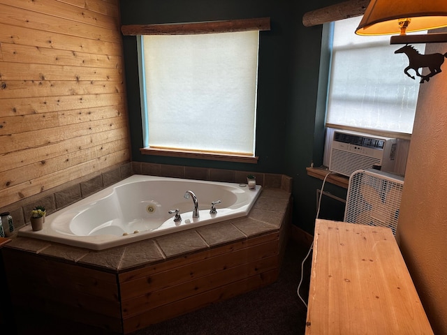 bathroom featuring cooling unit and a relaxing tiled tub