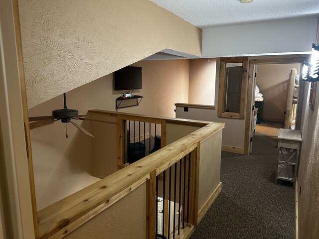 5900 Water Rd Unit 313, Rothbury, MI 49452 - corridor featuring a textured ceiling, baseboards, and carpet floors