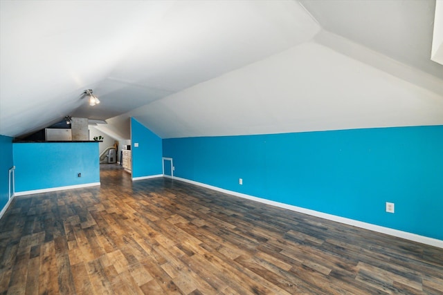 bonus room with dark hardwood / wood-style floors and lofted ceiling