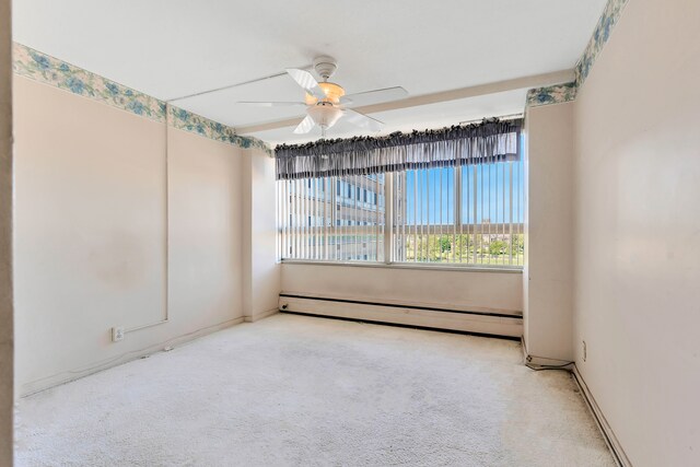 8900 E Jefferson Ave Unit 630-631, Detroit, MI 48214 - spare room featuring a baseboard radiator, ceiling fan, carpet, and baseboards