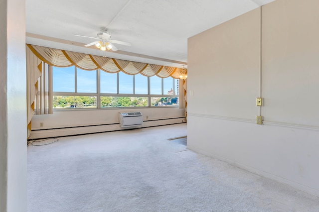 carpeted empty room featuring ceiling fan and a baseboard heating unit