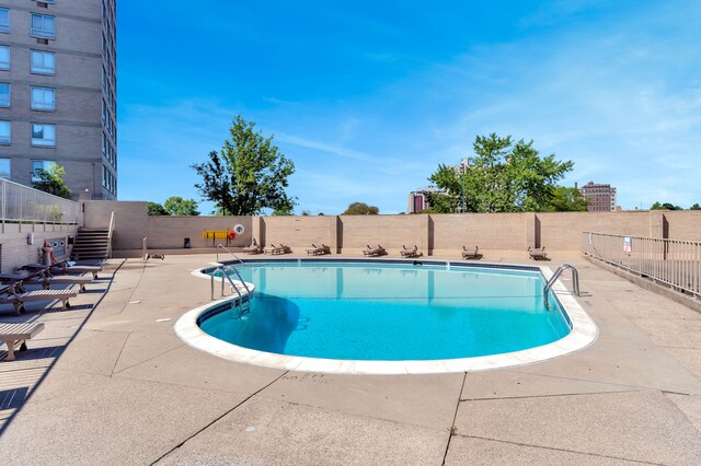 8900 E Jefferson Ave Unit 630-631, Detroit, MI 48214 - community pool with a patio area and stairs