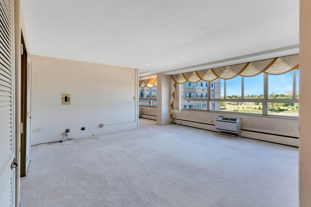 8900 E Jefferson Ave Unit 630-631, Detroit, MI 48214 - unfurnished living room with carpet floors and a baseboard radiator