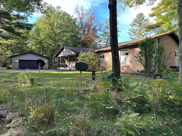 view of yard with a garage and an outdoor structure