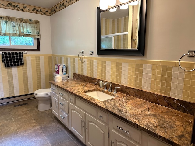 bathroom featuring vanity, tile walls, and toilet