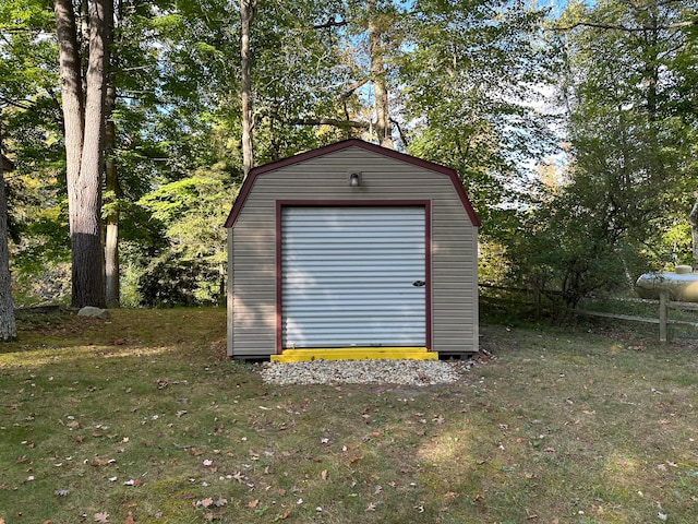 view of outbuilding featuring a lawn