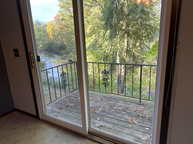 doorway featuring carpet floors and a water view