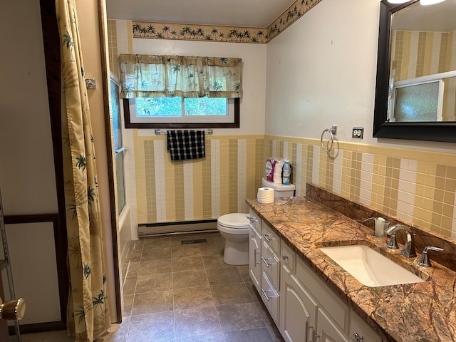 full bathroom with vanity, shower / tub combo with curtain, baseboard heating, tile walls, and toilet