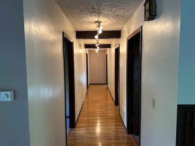 corridor with wood-type flooring