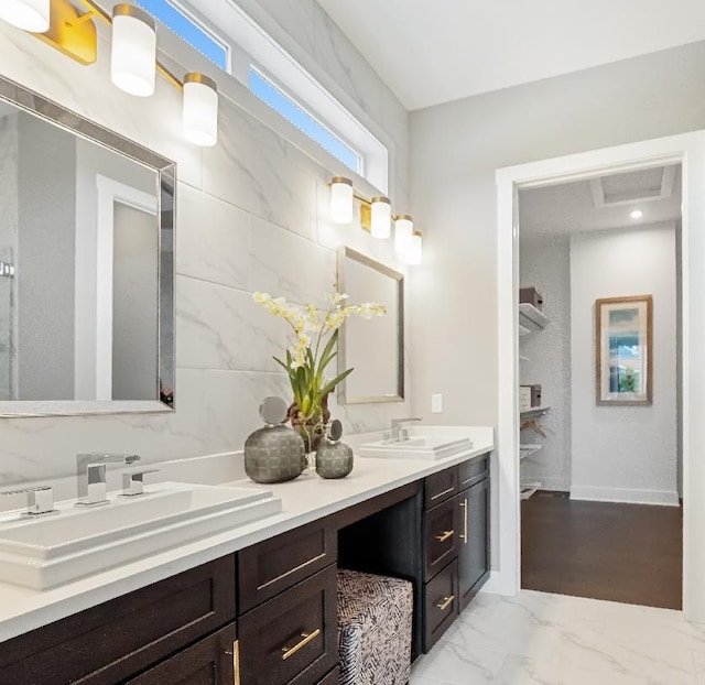 7893 Arimoore Dr, West Bloomfield, MI 48322 - full bathroom with double vanity, marble look tile flooring, and baseboards