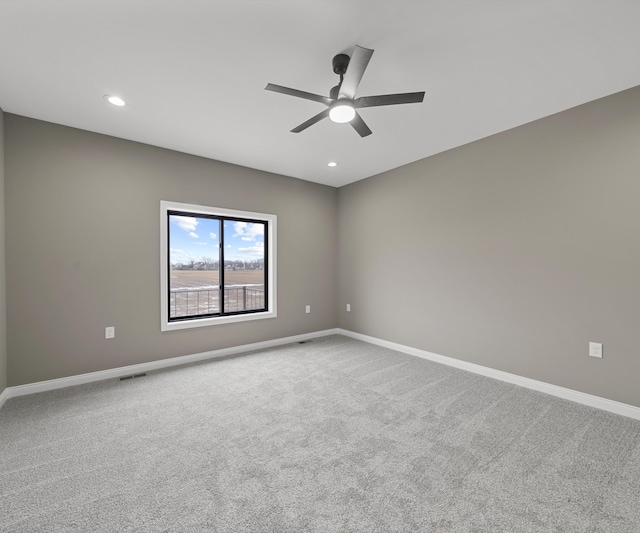 carpeted spare room featuring recessed lighting and baseboards