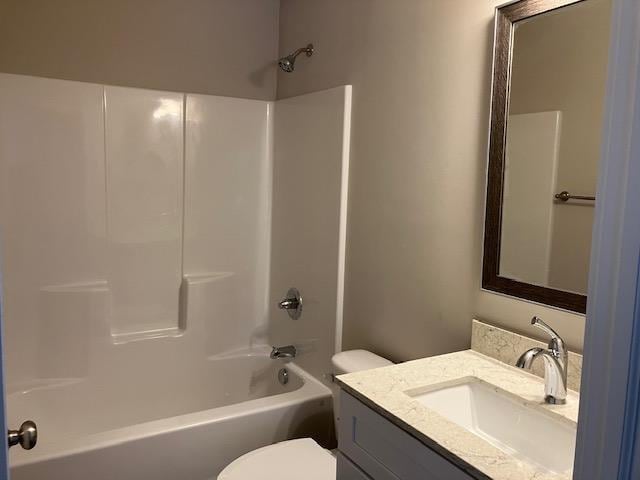 2715 Sawyer Rd, Traverse City, MI 49685 - bathroom with vanity, toilet, and tub / shower combination
