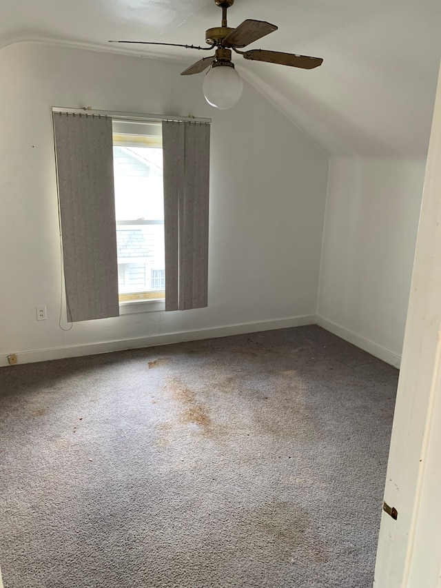 additional living space with carpet flooring, ceiling fan, and lofted ceiling