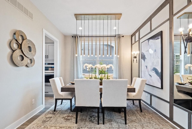 dining room with wood-type flooring