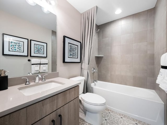 full bathroom featuring tile patterned floors, vanity, toilet, and tiled shower / bath