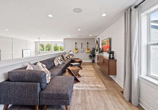 7889 Arimoore Dr, West Bloomfield, MI 48322 - living area featuring light wood-style floors, recessed lighting, and brick wall