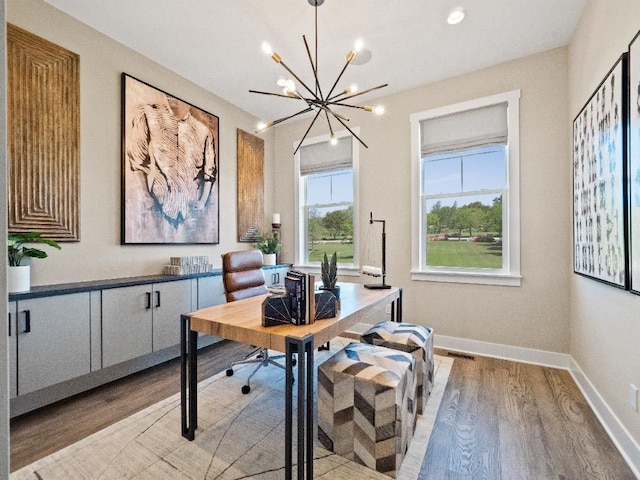 office space featuring a chandelier and light wood-type flooring