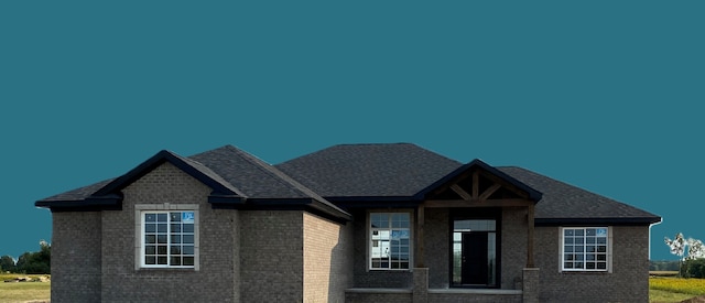 craftsman house with a front lawn and brick siding