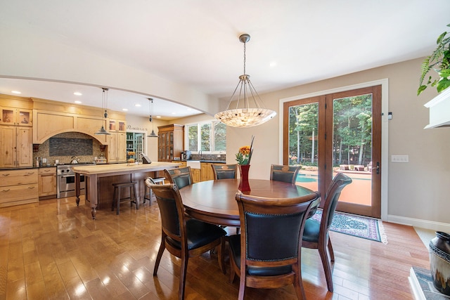 dining space featuring light wood-type flooring and a chandelier