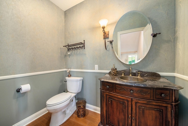 bathroom featuring vanity, hardwood / wood-style flooring, and toilet