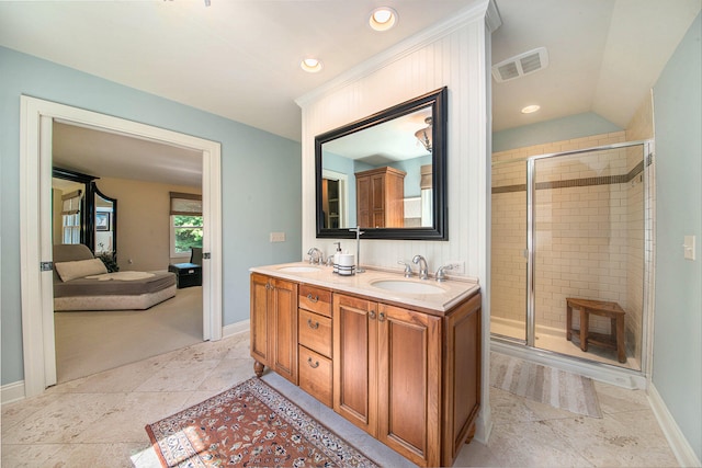 bathroom featuring vanity, a shower with shower door, and vaulted ceiling