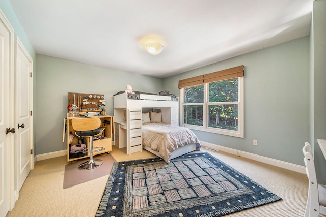 bedroom featuring light carpet