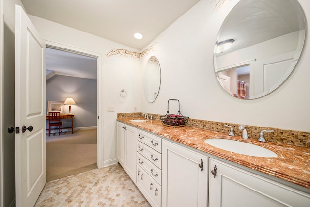 bathroom with vanity and vaulted ceiling