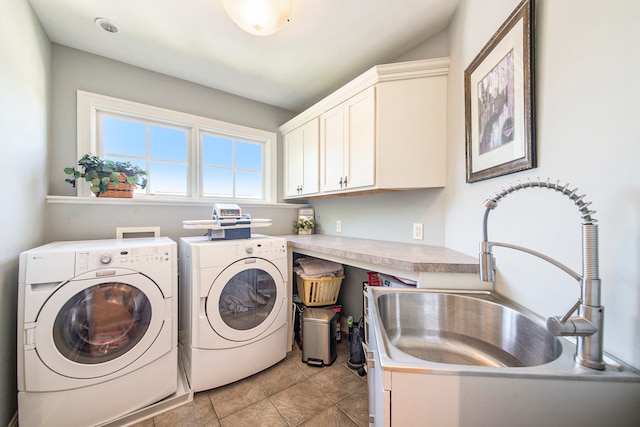 clothes washing area with cabinets, light tile patterned floors, separate washer and dryer, and sink