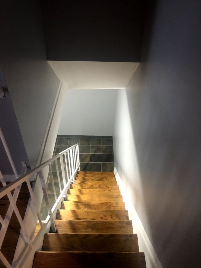 stairway with tile patterned floors