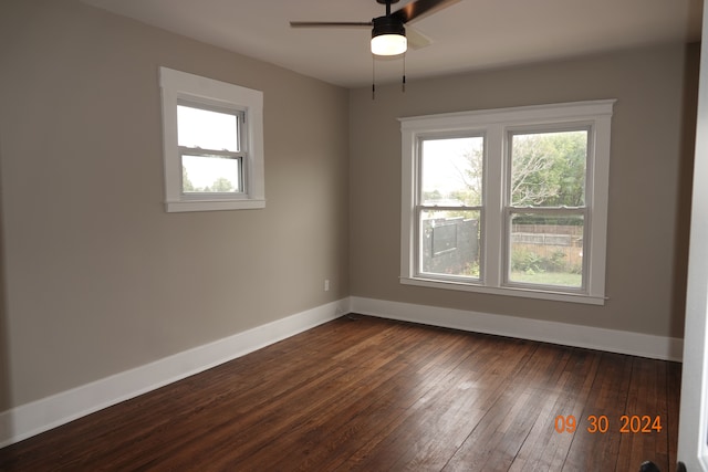 spare room featuring dark hardwood / wood-style flooring and ceiling fan