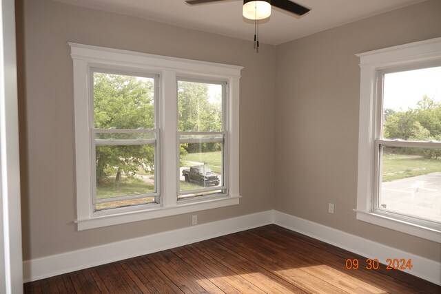 spare room featuring hardwood / wood-style flooring, plenty of natural light, and ceiling fan