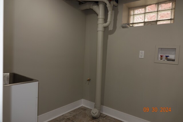 washroom with washer hookup and light tile patterned floors