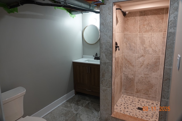 bathroom with vanity, a shower stall, and toilet