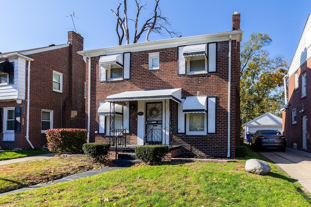 multi unit property featuring an outdoor structure, a front yard, and a garage